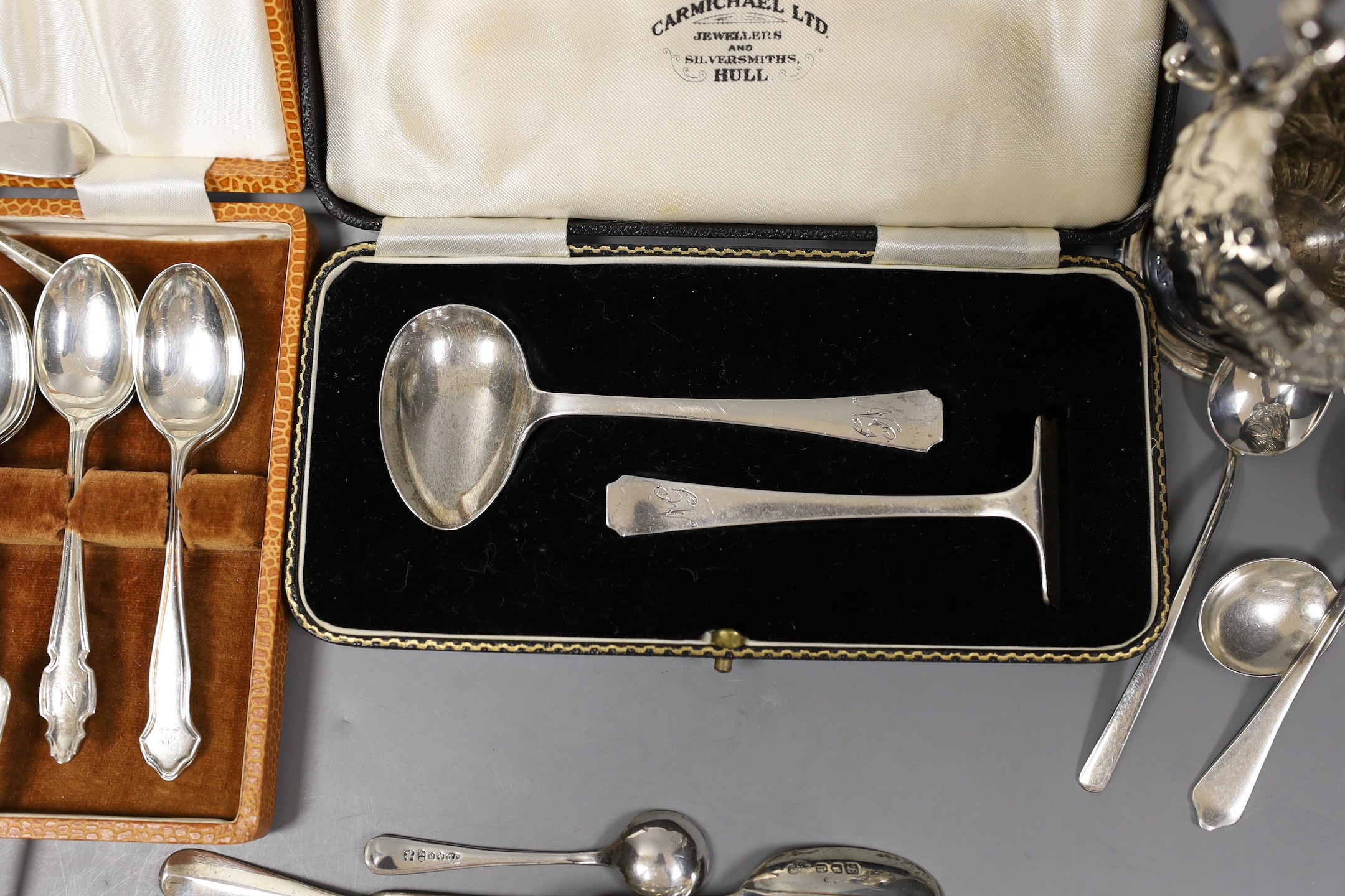 An Edwardian repousse silver oval dish, Birmingham, 1904, 22.8cm, a small quantity of assorted silver flatware including 18th and 19th century pairs of sugar nips, an 18th century silver toddy ladle, white metal cream ju